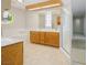 Bathroom featuring wood cabinets, double sinks, and a glass door shower at 904 Hibiscus Ct, Henderson, NV 89011