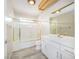 Updated bathroom featuring modern white cabinets, a shower/tub combo, and wood-look flooring at 904 Hibiscus Ct, Henderson, NV 89011