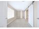 Large bedroom with tile floors, storage shelves and a sliding barn door into an ensuite bathroom at 904 Hibiscus Ct, Henderson, NV 89011