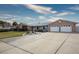 Single story home with a long driveway, mature landscaping, and a two-car garage at 904 Hibiscus Ct, Henderson, NV 89011