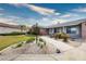Charming single story house with lush, desert landscaping and sidewalk leading to front door at 904 Hibiscus Ct, Henderson, NV 89011