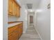 Hallway featuring wood-look flooring, a storage cabinet with a countertop and access to multiple rooms at 904 Hibiscus Ct, Henderson, NV 89011