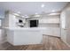 Modern kitchen featuring an island with a quartz countertop, white cabinetry and stainless steel appliances at 904 Hibiscus Ct, Henderson, NV 89011