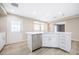 Beautifully remodeled kitchen with white cabinets, quartz countertops and stainless appliances at 904 Hibiscus Ct, Henderson, NV 89011