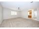 Spacious living room featuring neutral carpeting and an entrance to the kitchen and bathroom at 904 Hibiscus Ct, Henderson, NV 89011