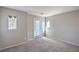 An empty bedroom features neutral colored walls and carpet and two windows for natural light at 9117 Careful Canvas Ave, Las Vegas, NV 89149