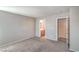 An empty bedroom features neutral colored walls and carpet with an ensuite bathroom at 9117 Careful Canvas Ave, Las Vegas, NV 89149