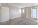 An empty bedroom features neutral colored walls and carpet, with a closet door visible at 9117 Careful Canvas Ave, Las Vegas, NV 89149