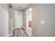 Bright foyer with gray walls and luxury vinyl plank flooring, leading into other rooms of the house at 9117 Careful Canvas Ave, Las Vegas, NV 89149