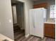 Bright kitchen showcasing wood cabinets, a white refrigerator, and decorative glass at 9117 Careful Canvas Ave, Las Vegas, NV 89149