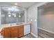 Galley style kitchen with stainless steel sink, wood cabinets, and white appliances at 9117 Careful Canvas Ave, Las Vegas, NV 89149