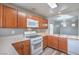 Functional kitchen featuring white appliances, wood cabinets, and a convenient gas range at 9117 Careful Canvas Ave, Las Vegas, NV 89149
