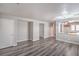Expansive living area featuring luxury vinyl plank flooring, multiple closets and entry to kitchen at 9117 Careful Canvas Ave, Las Vegas, NV 89149