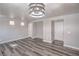 Open-concept living room with luxury vinyl plank flooring, modern light fixture, and neutral color palette at 9117 Careful Canvas Ave, Las Vegas, NV 89149