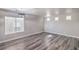 Spacious living room featuring luxury vinyl plank flooring, modern lighting, and ample natural light at 9117 Careful Canvas Ave, Las Vegas, NV 89149