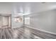 Open living area with luxury vinyl plank flooring, leading to the kitchen with bright neutral paint at 9117 Careful Canvas Ave, Las Vegas, NV 89149