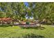 Community playground surrounded by trees, perfect for families with children at 9117 Careful Canvas Ave, Las Vegas, NV 89149