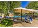 Community pool area with shaded seating, perfect for relaxation and socializing at 9117 Careful Canvas Ave, Las Vegas, NV 89149