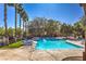 Relaxing community pool featuring lounge chairs and mature landscaping at 9117 Careful Canvas Ave, Las Vegas, NV 89149