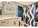 Bathroom featuring updated vanity, modern lighting, and decorative shower curtain at 950 Seven Hills Dr # 814, Henderson, NV 89052