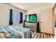 Bedroom features a large television, wood look floors and natural lighting at 950 Seven Hills Dr # 814, Henderson, NV 89052