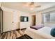 Bedroom featuring a TV, dresser, closet, ensuite bathroom and hardwood-style flooring at 950 Seven Hills Dr # 814, Henderson, NV 89052
