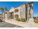 Attractive two-story condo building with balconies, stairs and desert landscaping at 950 Seven Hills Dr # 814, Henderson, NV 89052