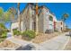 Attractive condo building with well-kept landscaping and palm trees under a clear blue sky at 950 Seven Hills Dr # 814, Henderson, NV 89052