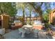 Community grilling area with stone table, built-in barbecues, and mature trees at 950 Seven Hills Dr # 814, Henderson, NV 89052