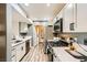 Bright kitchen with stainless steel appliances, white cabinetry, and wood-look flooring at 950 Seven Hills Dr # 814, Henderson, NV 89052