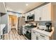 Well-lit kitchen featuring stainless steel appliances, white cabinets, and modern countertops at 950 Seven Hills Dr # 814, Henderson, NV 89052