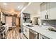 Updated kitchen with stainless steel appliances, wood-look flooring, and white cabinets at 950 Seven Hills Dr # 814, Henderson, NV 89052
