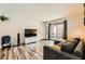 Bright living room featuring a large TV, comfortable sofa, and sliding glass door at 950 Seven Hills Dr # 814, Henderson, NV 89052
