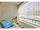 Relaxing outdoor patio space with comfortable blue chair, table, and privacy screen at 950 Seven Hills Dr # 814, Henderson, NV 89052