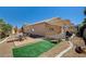 Fully fenced backyard with artificial turf, desert landscaping, and covered patio, great for entertaining at 97 Zimmerman St, Henderson, NV 89002