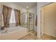 Bright bathroom with tub, shower and window at 97 Zimmerman St, Henderson, NV 89002