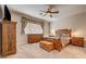 Bedroom with wooden furniture, a ceiling fan, and neutral decor at 97 Zimmerman St, Henderson, NV 89002