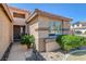 The entryway shows desert landscaping, neutral stucco, a stone walkway and a decorative front door at 97 Zimmerman St, Henderson, NV 89002