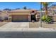 Charming single-story home featuring a desert landscape, tile roof and a two-car garage at 97 Zimmerman St, Henderson, NV 89002