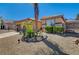 A single story house with a desert landscape and palm trees is shown in the summer sun at 97 Zimmerman St, Henderson, NV 89002