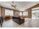 Bright living room with ceiling fans, tile flooring and a glass slider door at 97 Zimmerman St, Henderson, NV 89002