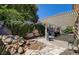 This backyard boasts a covered patio, stone accents, and mature landscaping for outdoor enjoyment at 97 Zimmerman St, Henderson, NV 89002