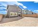 Backyard featuring a sandy area, brick walls, and sliding glass doors at 1027 Gentle Swan St # 689, Henderson, NV 89011