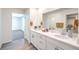 Bright bathroom features a double sink vanity, quartz countertop, and neutral decor at 1027 Gentle Swan St # 689, Henderson, NV 89011