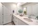 Modern bathroom with double sink vanity, quartz countertops, and neutral decor at 1027 Gentle Swan St # 689, Henderson, NV 89011