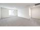 Large bedroom with neutral carpet, white walls, and a bright window providing natural light at 1027 Gentle Swan St # 689, Henderson, NV 89011