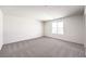 Neutral bedroom with carpet, bright window offering natural light, and clean, white walls at 1027 Gentle Swan St # 689, Henderson, NV 89011