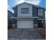Two-story home featuring a two-car garage, stone accents, and low-maintenance landscaping at 1027 Gentle Swan St # 689, Henderson, NV 89011