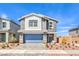 Charming two-story home featuring a stone-accented facade, paver driveway, and well-maintained landscaping at 1027 Gentle Swan St # 689, Henderson, NV 89011
