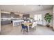Bright, open-concept kitchen with gray cabinetry, stainless steel appliances, and center island with seating at 1027 Gentle Swan St # 689, Henderson, NV 89011